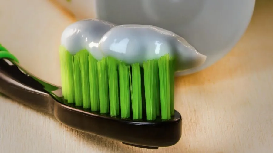 Close-up of someone inspecting dental care products with focused attention to detail and quality