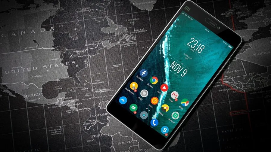 Close-up of someone inspecting smartphone display with protective glass coating