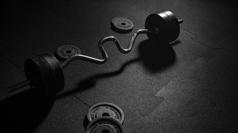 Close-up of spinning weight plates on a barbell during a strength training workout