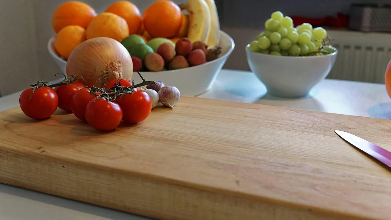 Close-up of steak knife set with serrated blades arranged on wooden cutting board