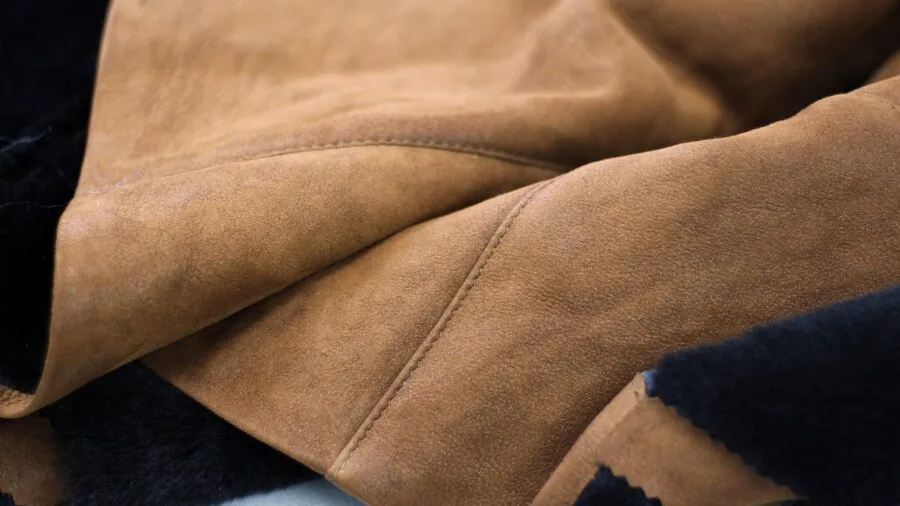 Close-up of various fabric textures and materials arranged for sewing project selection