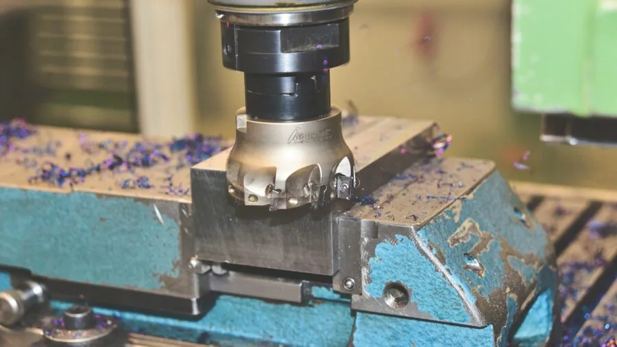 Close-up of various metal fasteners and tools in a practical workshop setting showing corrosion-resistant materials