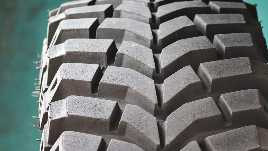 Close-up of vehicle tire on wet asphalt road during rainy weather conditions