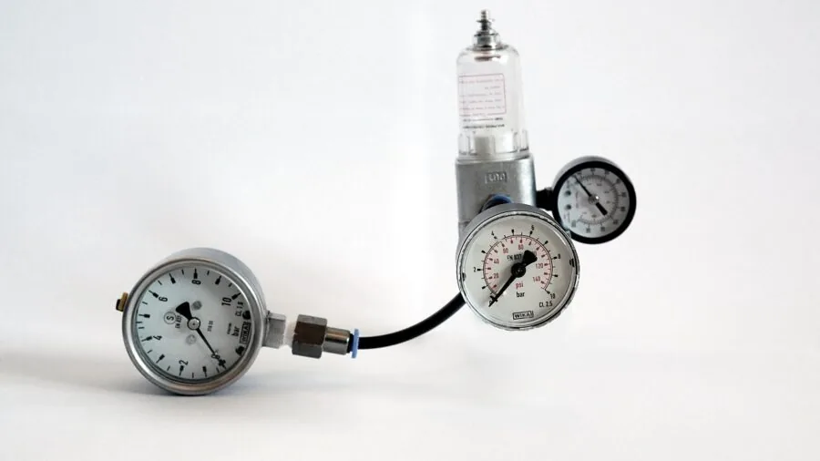 Close-up of water pressure gauge being checked during RV campground hookup setup