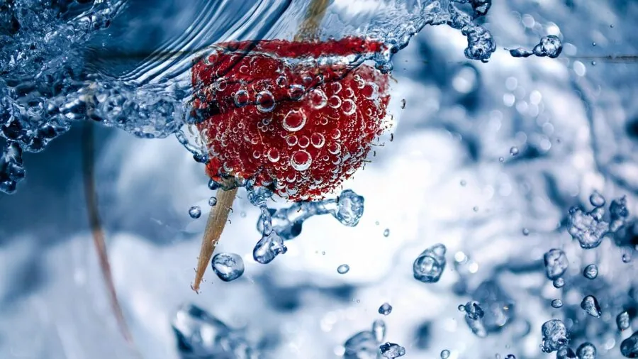Close-up of water spraying dishes during wash cycle, showcasing cleaning action and dishwasher performance