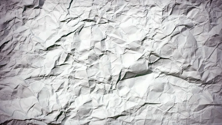 Close-up of weathered, sun-bleached fabric showing UV degradation and discoloration from prolonged outdoor exposure