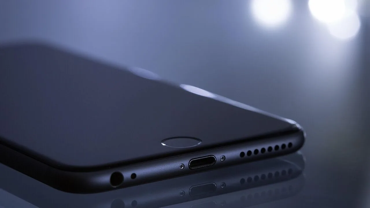 Close-up of wireless earbuds displayed against neutral background