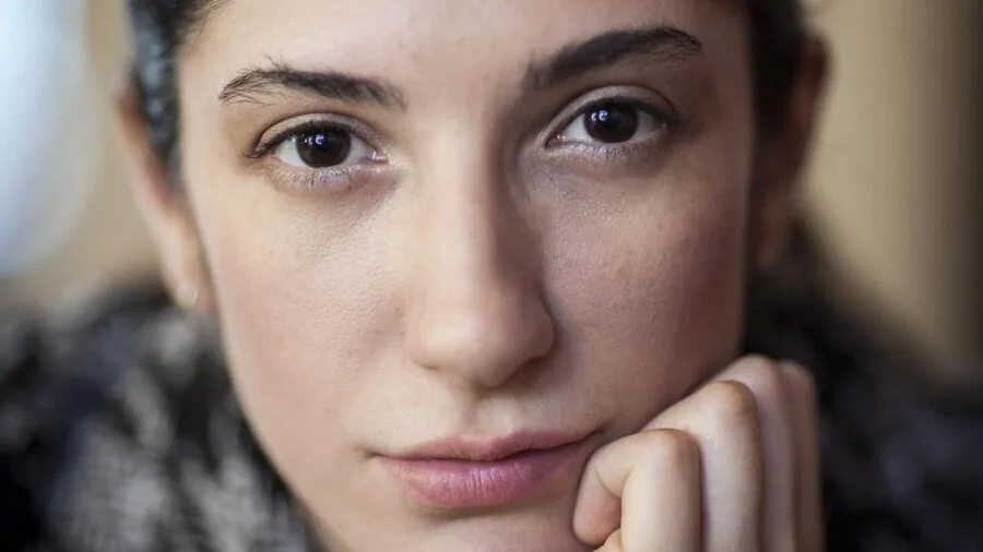 Close-up of woman with natural, glowing complexion and fresh skin in natural lighting