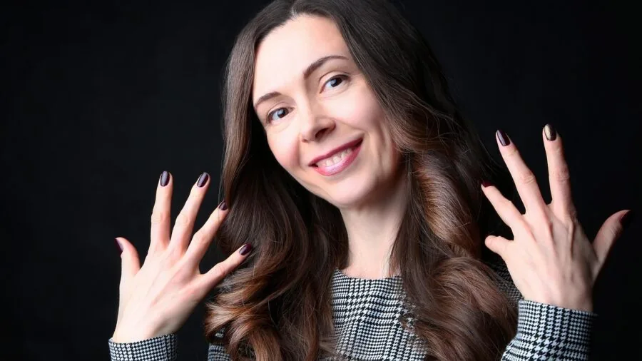 Close-up of woman's hands showing well-maintained gel manicure after two weeks without chipping