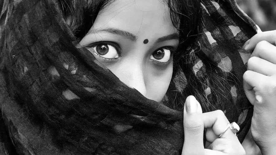 Close-up of woman's hands stretching elastic fabric to demonstrate stretch and recovery quality