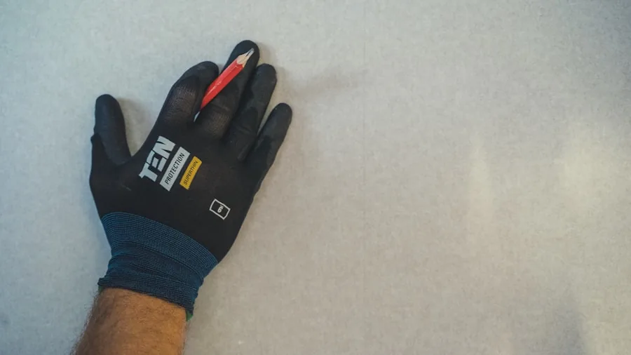 Close-up of worker's hands in protective gloves during manual labor task
