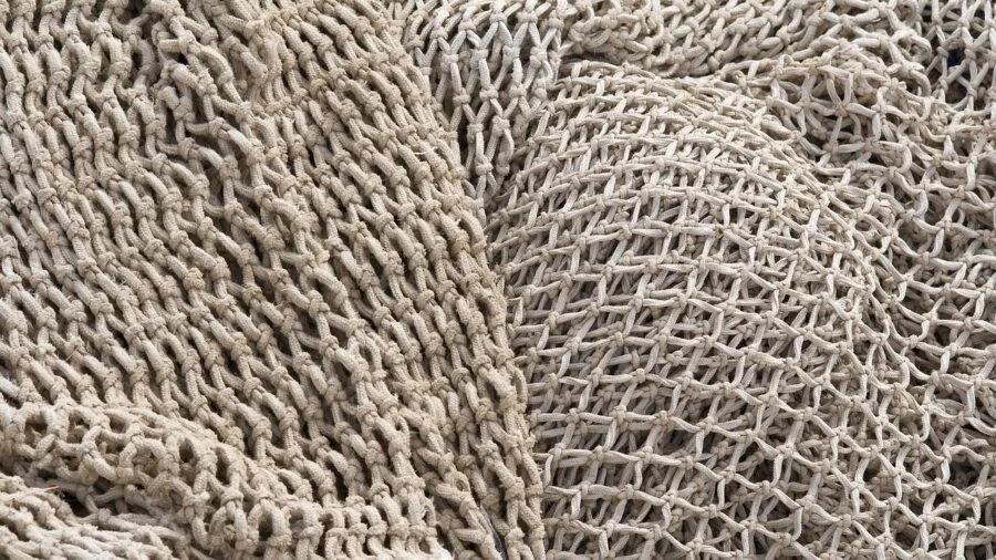 Close-up of woven fabric texture showing durable interlocked threads in a woven pattern design