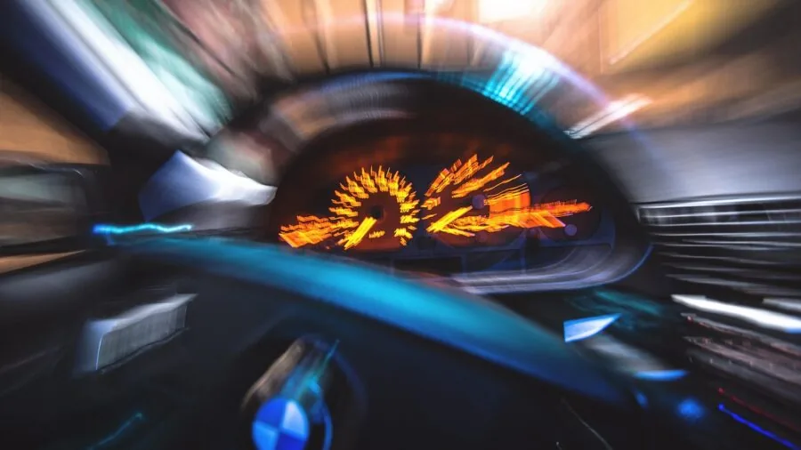 Close-up view of a car dashboard showing air vents, sensors, and speakers integrated into the design