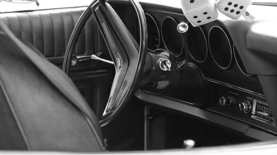 Close-up view of a car dashboard showing heat effects and electronic components in bright sunlight