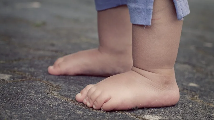 Close-up view of a runner's feet and shoes hitting the pavement during an outdoor jog