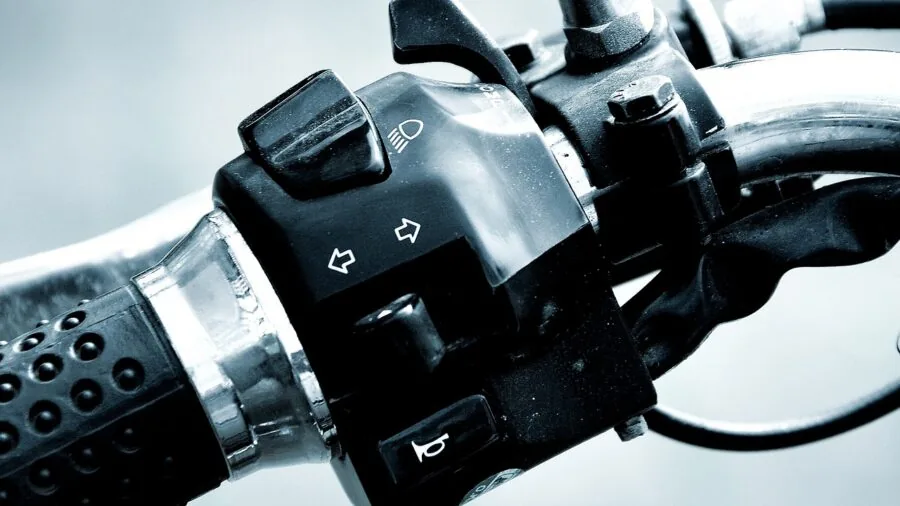 Close-up view of different motorcycle handlebar types and diameters on various bikes