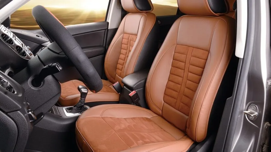 Close-up view of seat belt mechanism being installed in vehicle interior