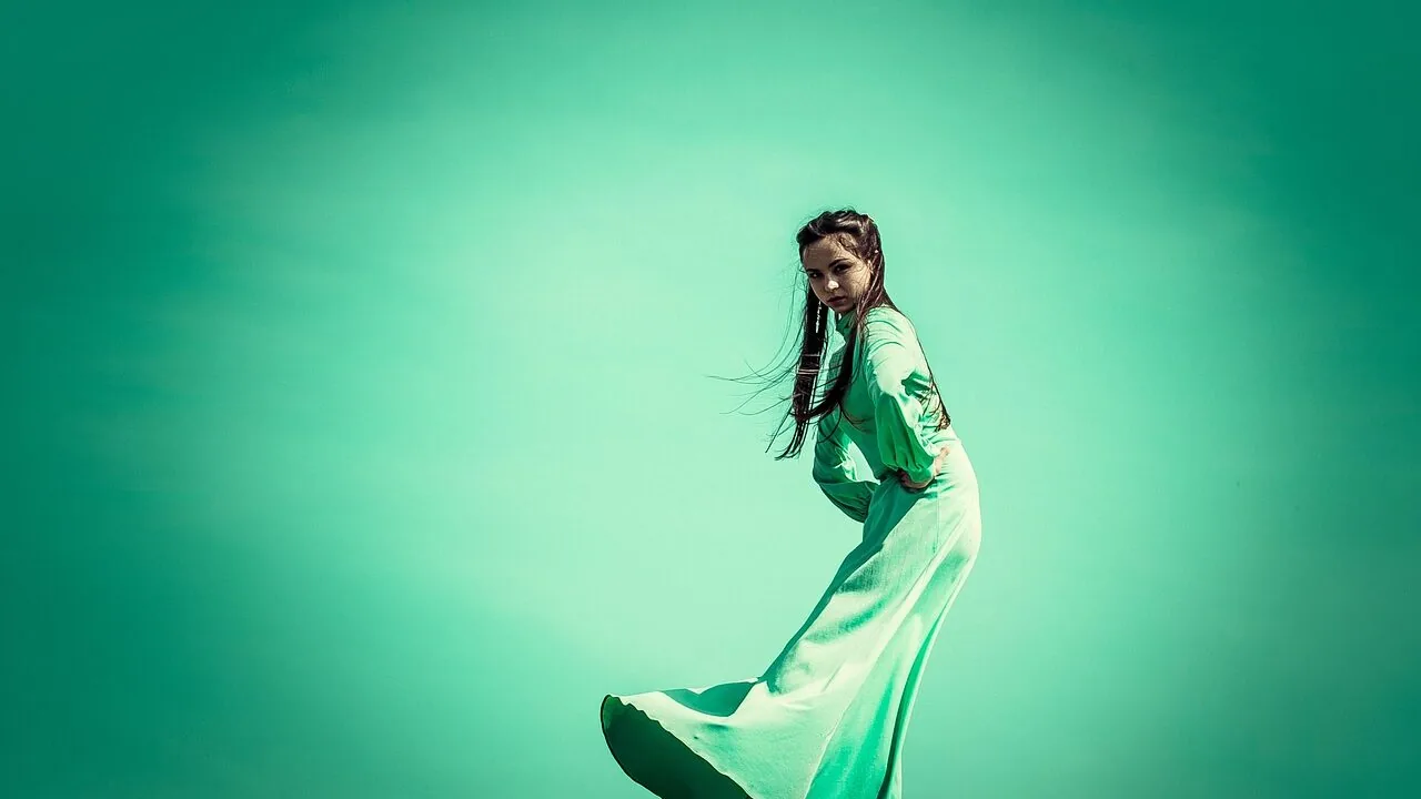 Collection of colorful women's summer dresses displayed on dress form or model