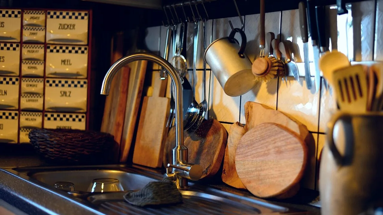 Collection of wooden and plastic cutting boards on kitchen counter with natural light