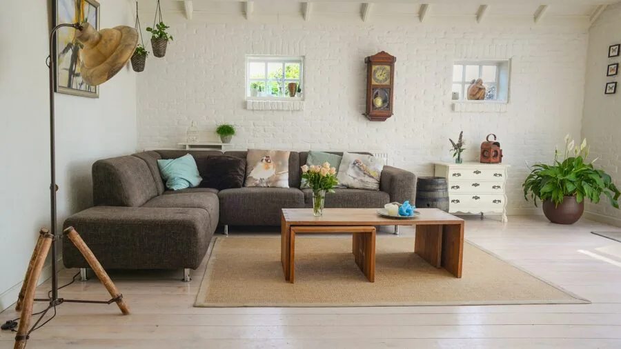 Colorful botanical and impressionist art prints displayed on a living room wall in natural light