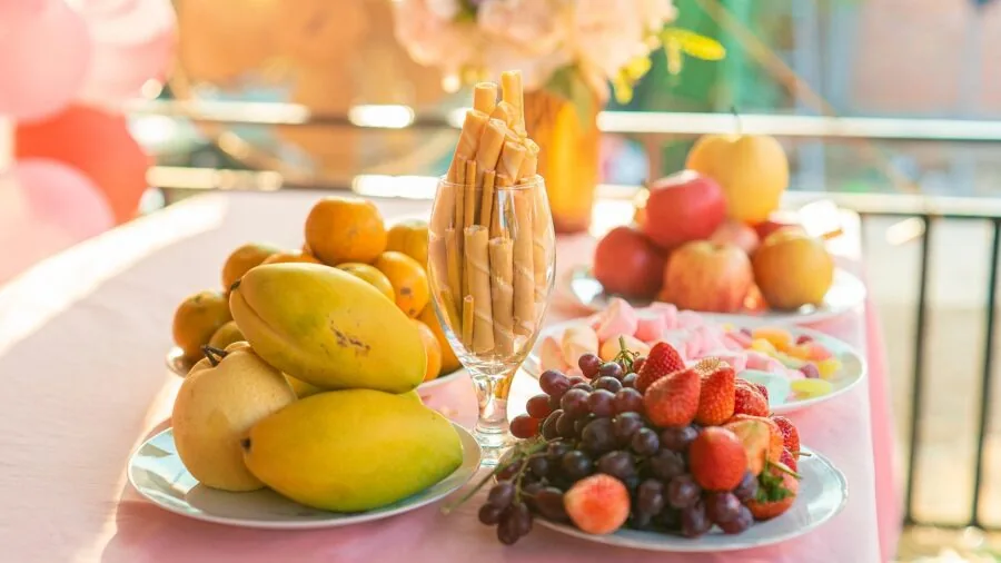 Colorful ceramic dishes and plates arranged on an outdoor dining table with natural lighting