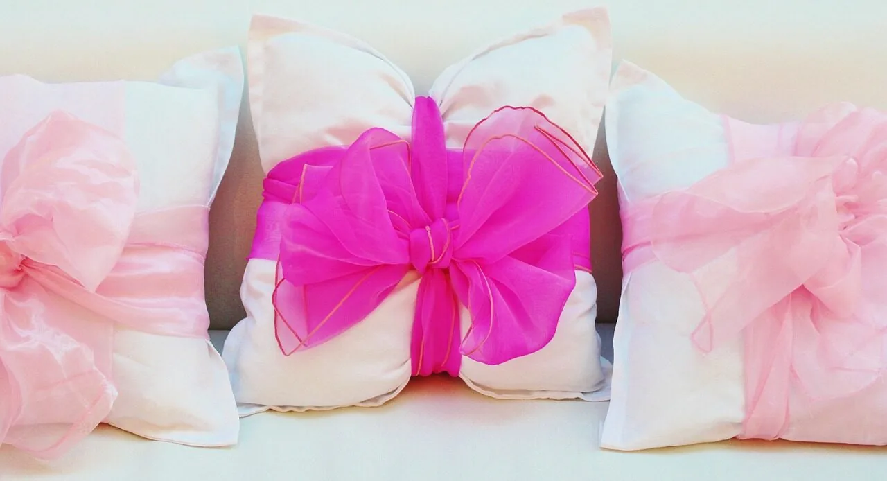 Colorful decorative pillow covers arranged on a sofa in natural lighting
