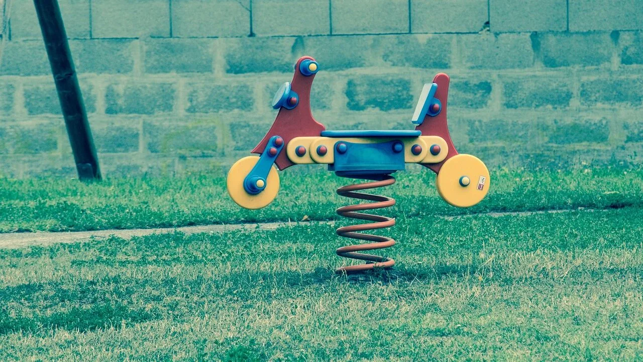 Colorful kids bikes displayed outdoors on ground showing different sizes and styles