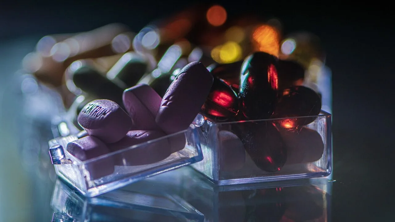 Colorful multivitamin bottles and supplement pills displayed together on white background