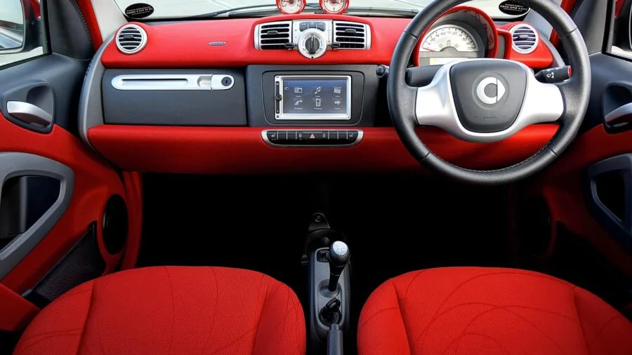 Commercial truck dashboard and steering wheel interior during daytime driving