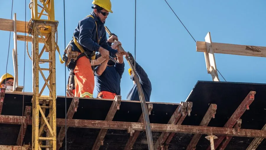 Construction worker setting up and positioning equipment on an active jobsite for efficient workflow