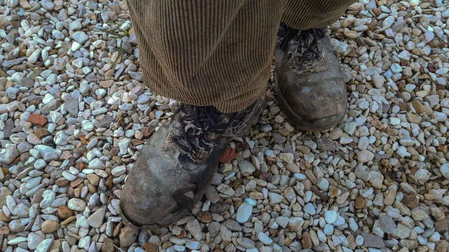 Construction worker wearing boots standing on job site during work shift