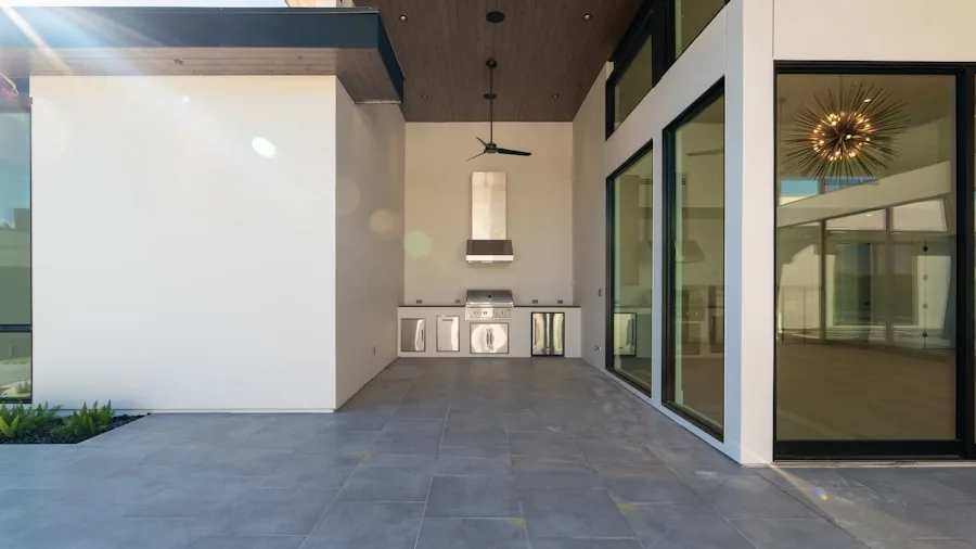 Contemporary backyard patio with comfortable seating and entertainment technology for outdoor living