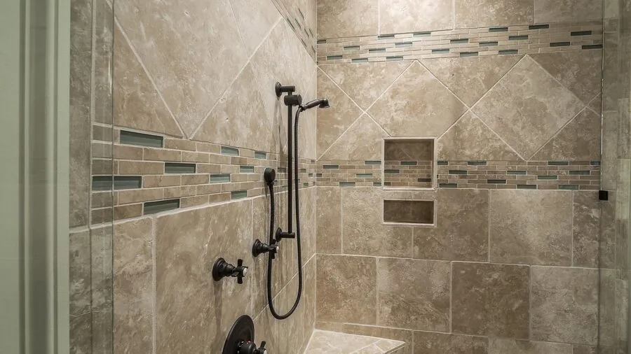 Contemporary bathroom interior with sleek wall-mounted shower fixture and clean minimalist design