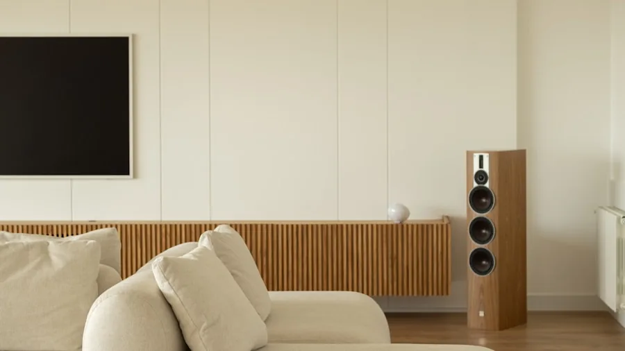 Contemporary living room with various speaker systems displayed on shelves and furniture