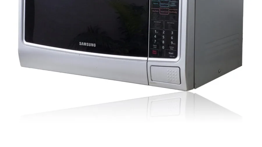 Cook reading temperature gauge in bright kitchen with natural sunlight streaming through windows