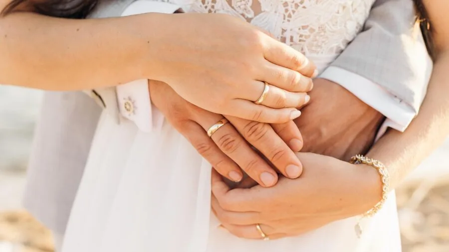 Couple closely inspecting a diamond engagement ring to evaluate stone quality and setting