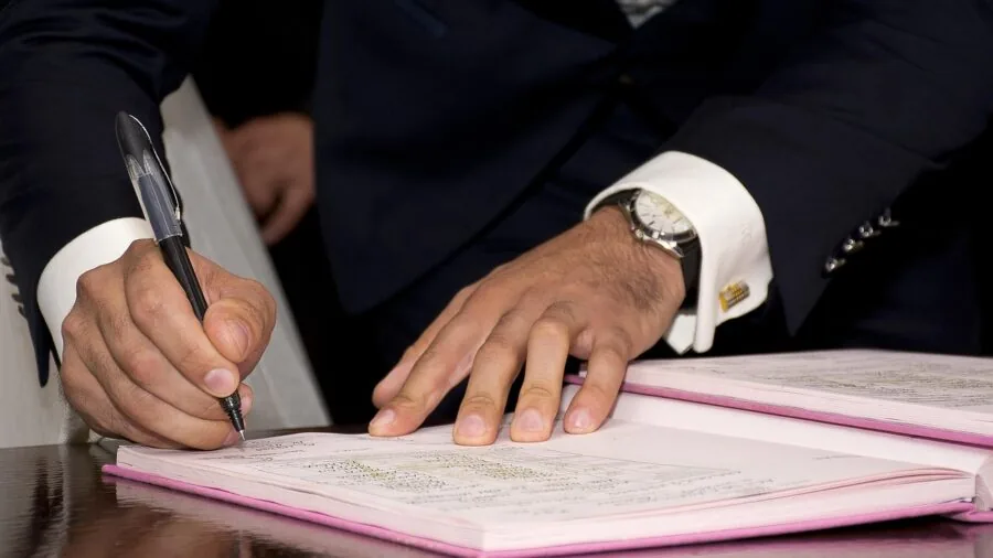 Couple examining gemstone certification paperwork together at home, discussing engagement ring authenticity
