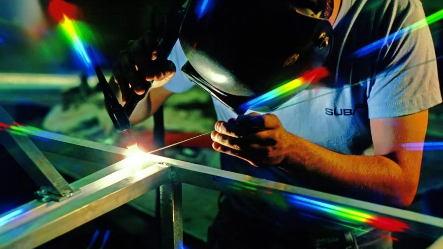 Craftsperson wearing protective eyewear while working in workshop environment