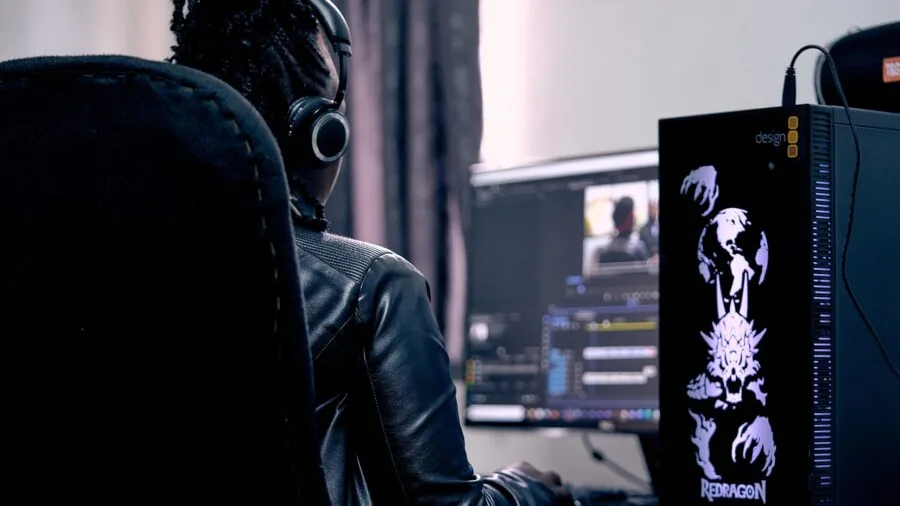 Creative professional editing immersive 360 video content on desktop computer setup in modern workspace