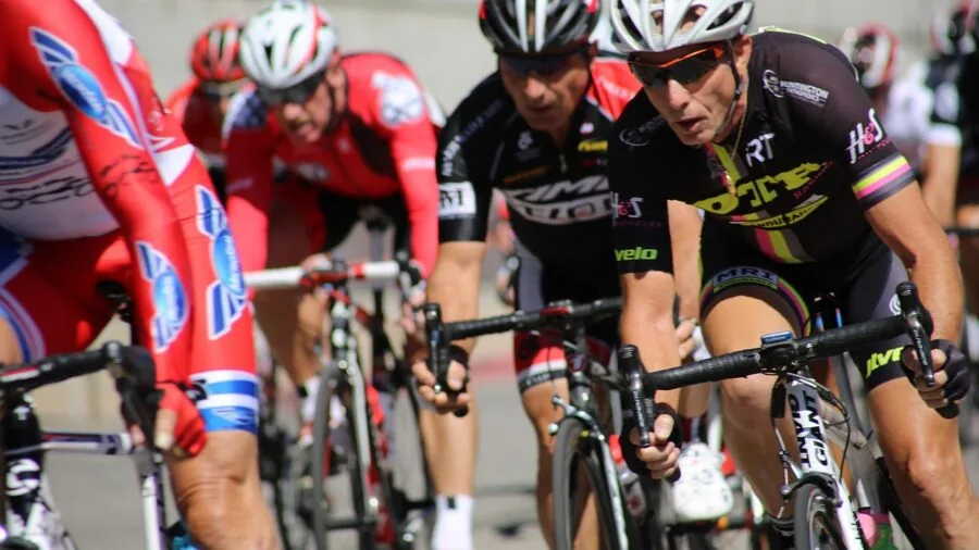 Cyclist in motion riding bike at speed on road, demonstrating active cycling performance and stability