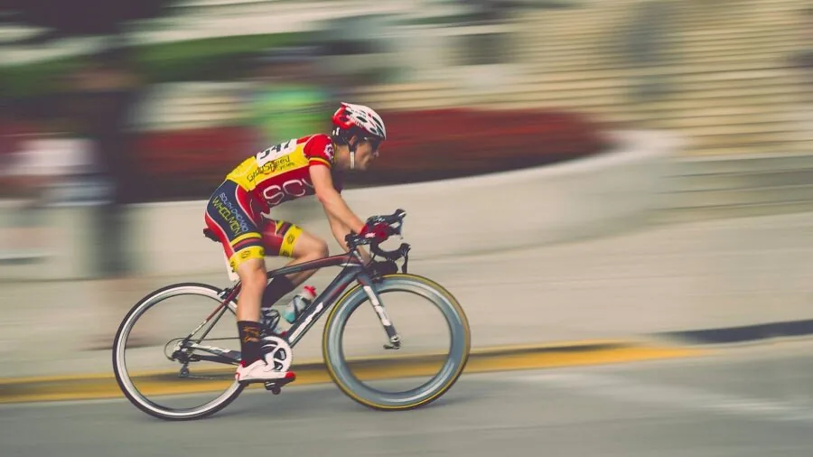 Cyclist making adjustments to their bicycle frame for proper fit and comfort before riding