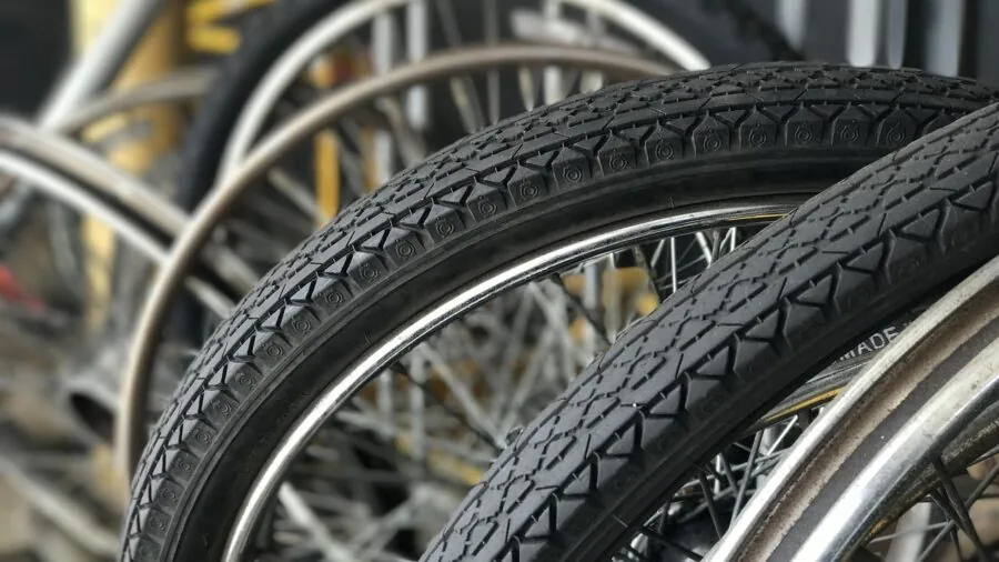 Cyclist performing tire repair on road bike during outdoor ride