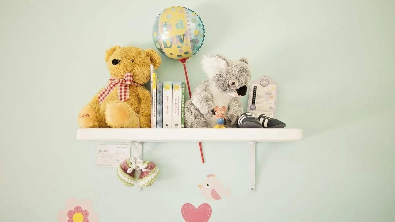 Digital baby monitor displaying video feed on nursery furniture shelf