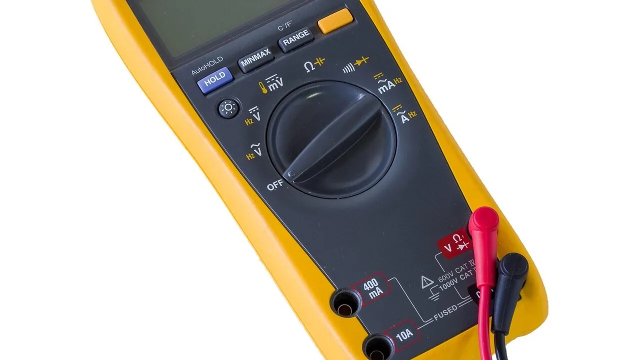 Digital multimeter with probes measuring circuit on electronics workbench