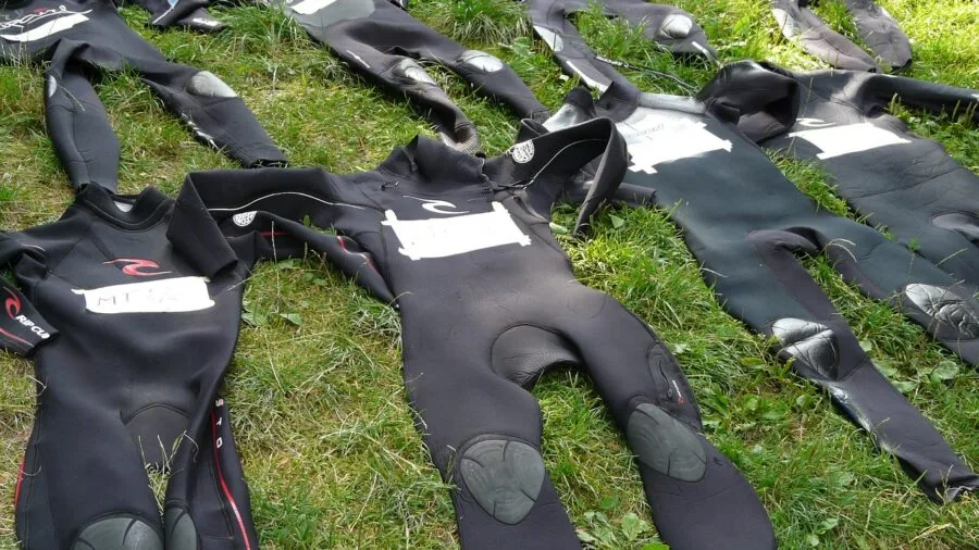 Diver in neoprene suit preparing for underwater exploration in natural water environment