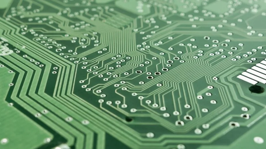 DIY electronics enthusiast working on indoor hobby project with soldering equipment