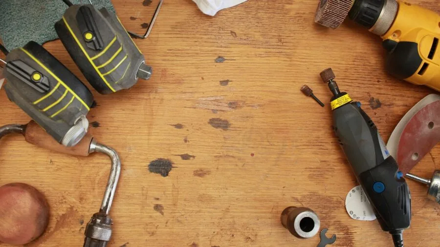 DIYer using oscillating multi-tool on wooden project in home workshop setting