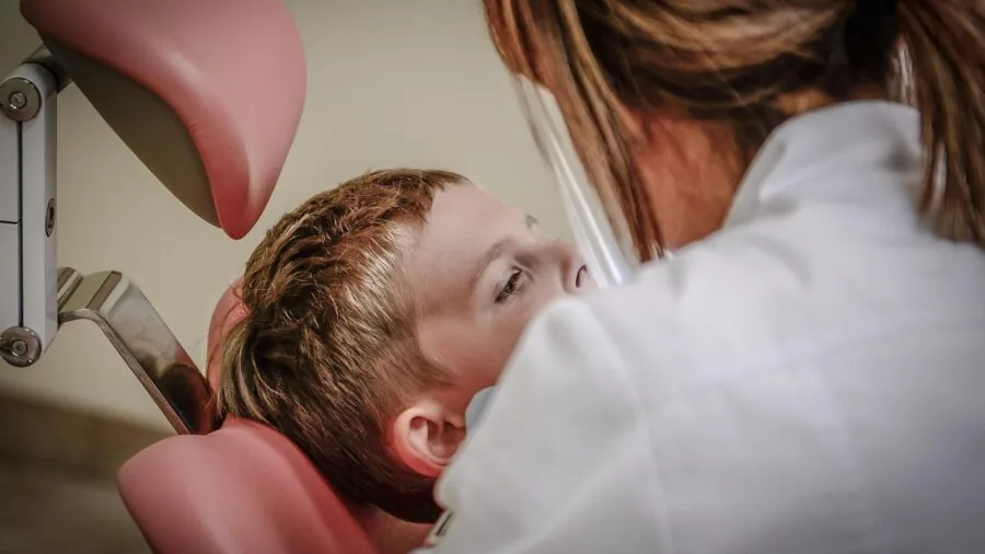 Doctor examining patient skin during dermatology consultation in clinical setting