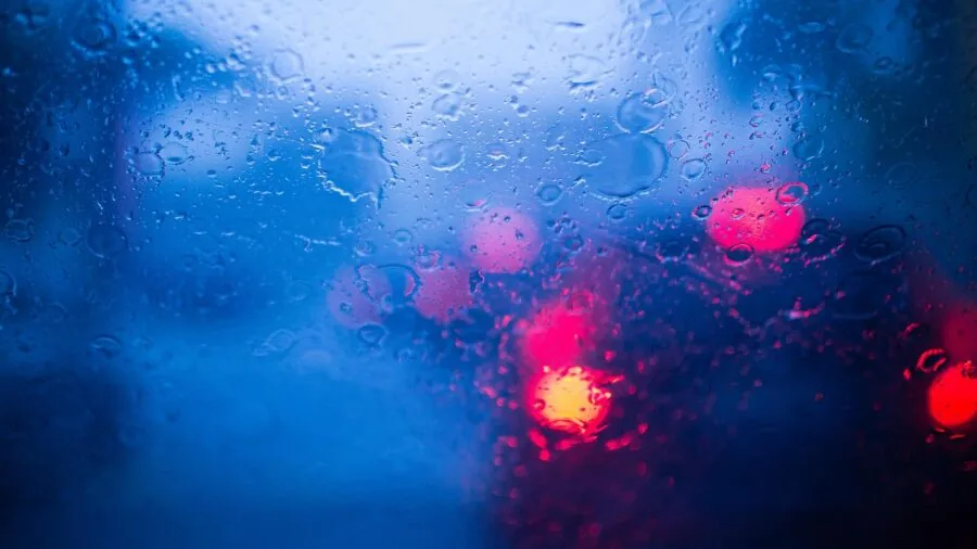 Driver checking road visibility at night with clear dashboard view and headlights illuminating the path ahead