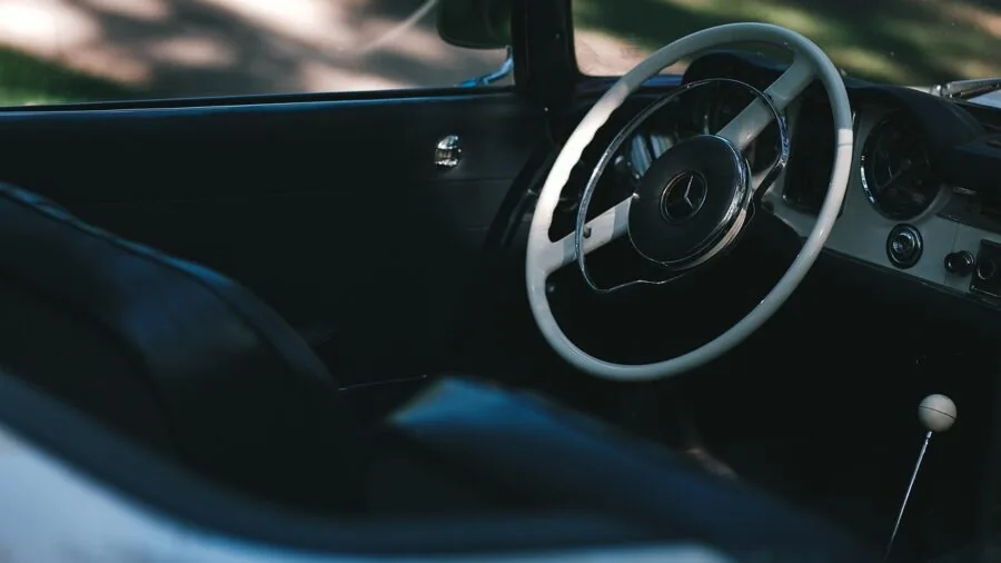 Driver enjoying fresh scent inside vehicle cabin with natural light